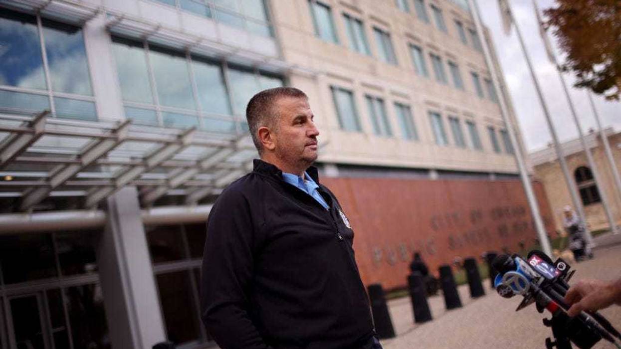 Fraternal Order of Police President John Catanzara speaks to the press as Chicago police officers and their supporters protest the department's vaccination policy outside of police headquarters on October 26, 2021 in Chicago, Illinois. The city has started to place police officers on unpaid leave for refusing to comply with the city's requirements that they report their COVID-19 vaccination status. As of last week, only about 65 percent of the city's police have complied with the order.