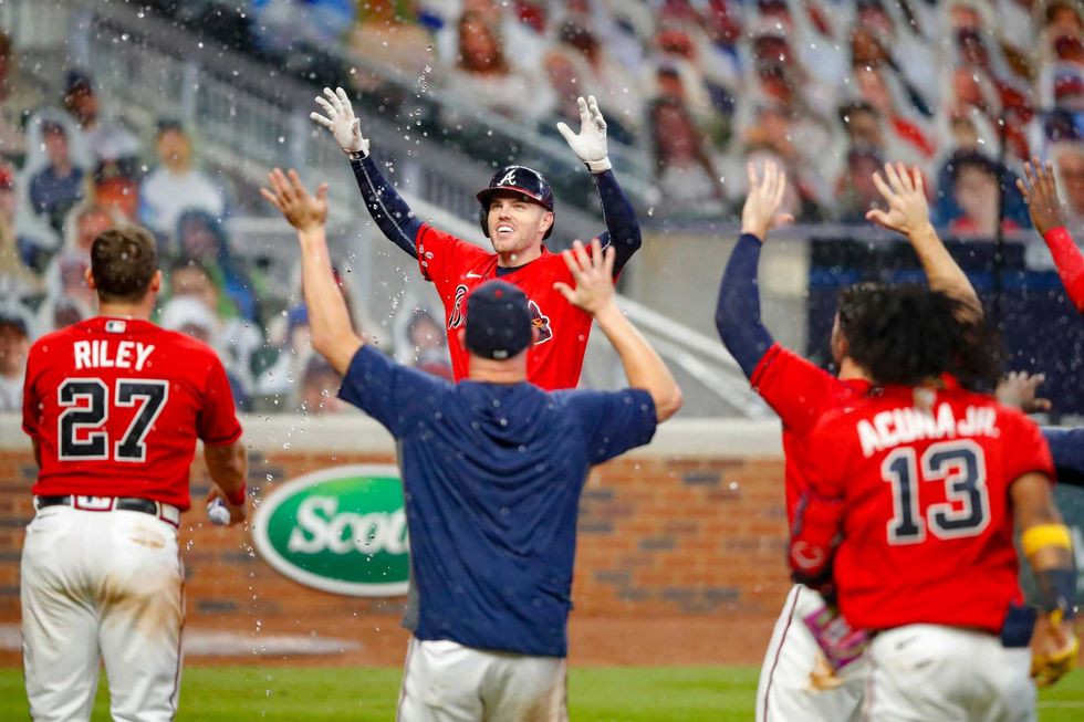 Freddie Freeman celebrates with teammates after beating the Red Sox on a walk-off home run