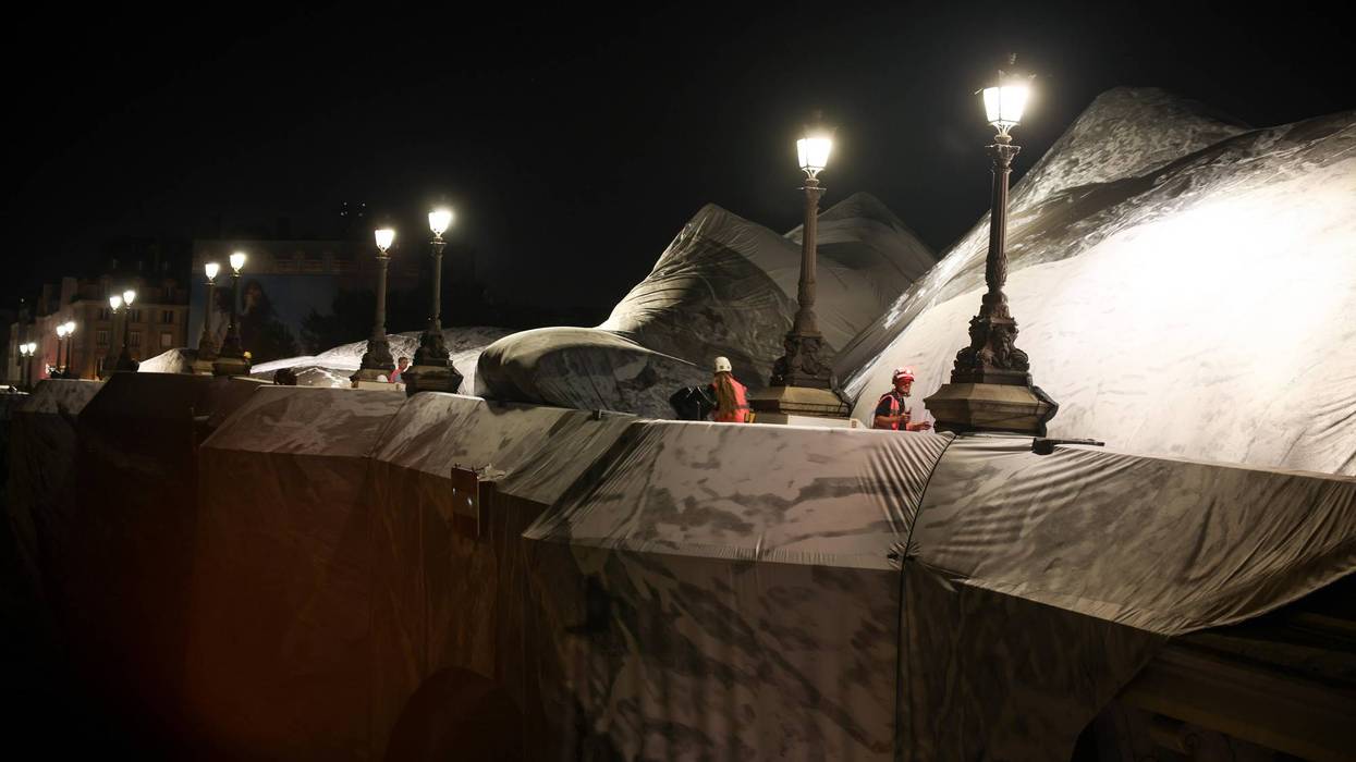 French artist JR begins his giant ‘cave’ art inflation over Paris’ oldest bridge