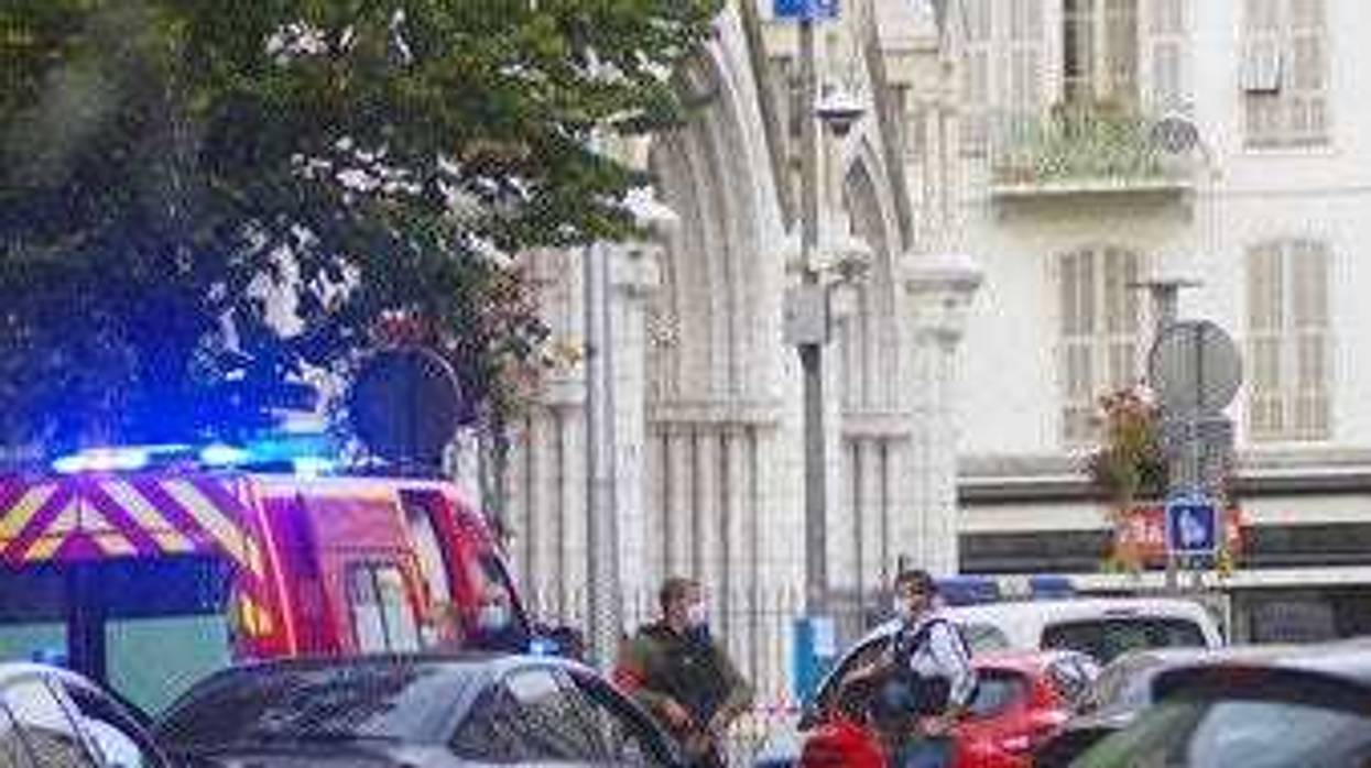 French policemen stand next to Notre Dame church after a knife attack, in Nice, France, Thursday, Oct. 29, 2020. (AP Photo/Alexis Gilli)