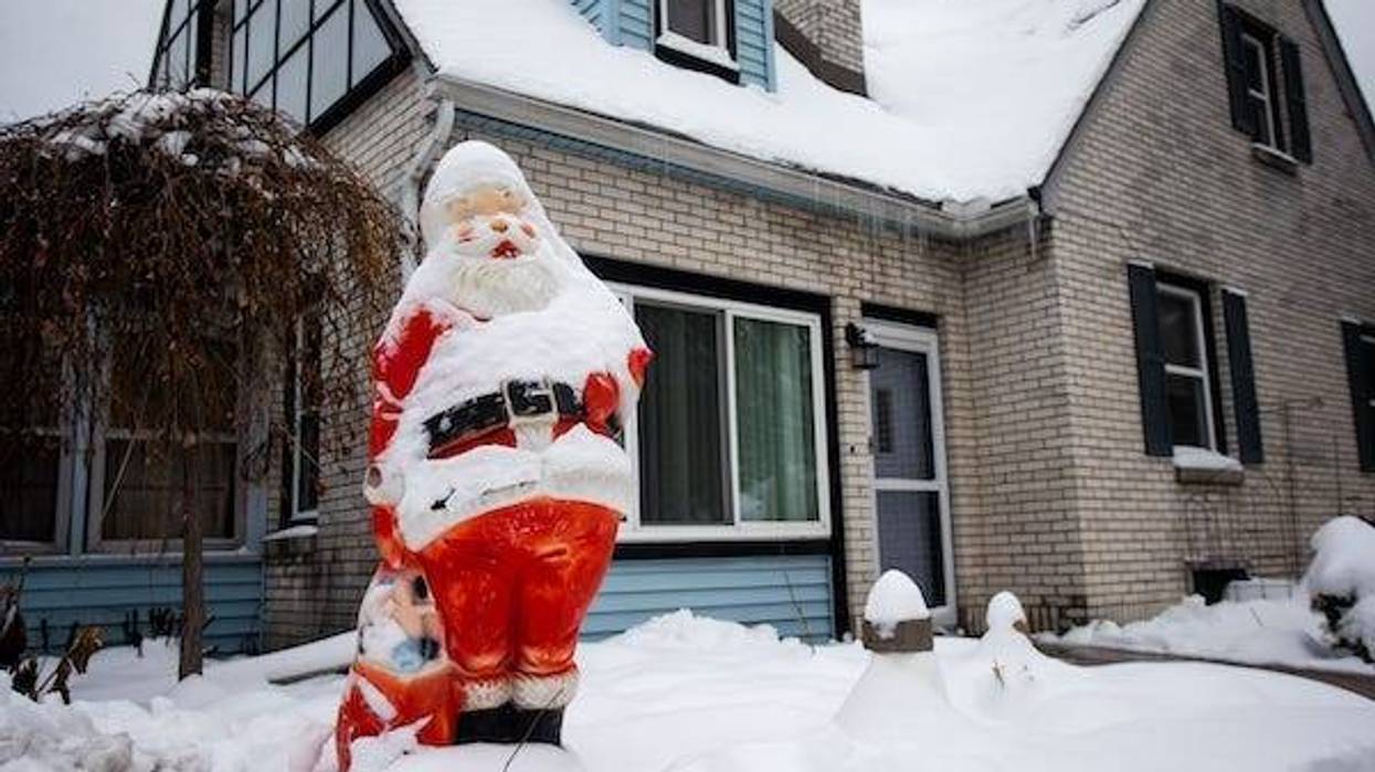 Fresh snow on Santa decoration outside home