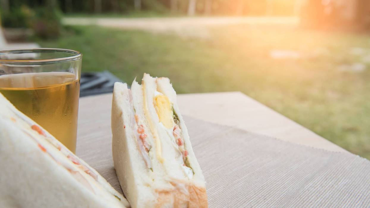 Freshly made Club sandwich and Juice on a cloth