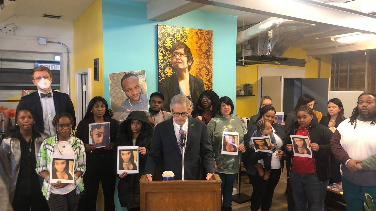Friends and family hold pictures of transgender people who have been killed in Philadelphia