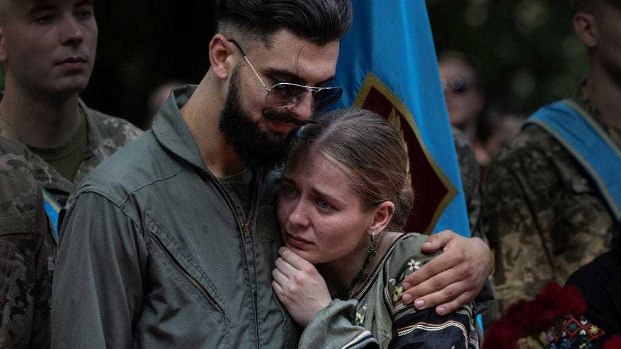 Friends and relatives mourn the death of fighter pilot Andrii "Juice" Pilshchykov, 30, who was killed along with two other pilots in a tragic mid-air plane crash in Kyiv, Ukraine on August 29, 2023. Andrii Pilshchykov was known as an excellent communicator trying to reform the Ukraine Air Force, lobbying hard for the F-16 fighter jets to be sent to Ukraine. (Photo by Paula Bronstein /Getty Images)