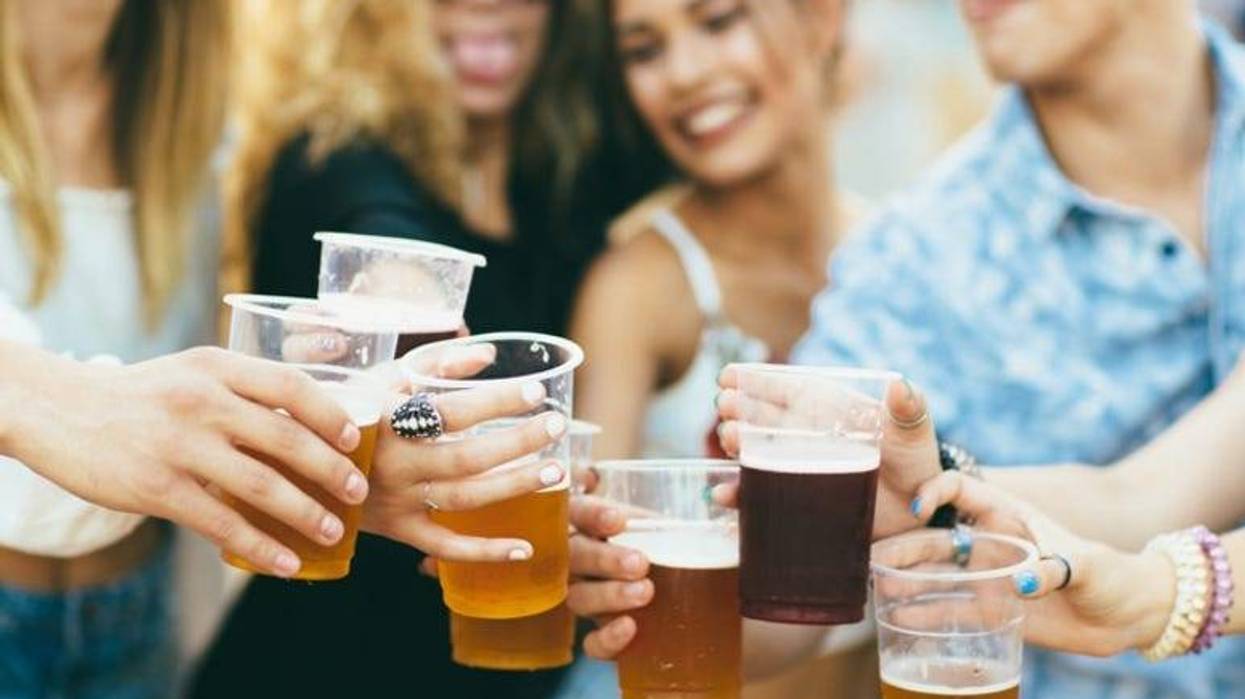 Friends drinking beer and having fun at festival