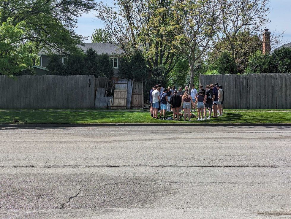 friends gather around near crash site