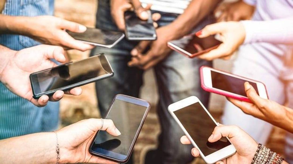 Friends group having addicted fun together using smartphones - Hands detail sharing content on social network with mobile smart phone - Technology concept with people millennials online with cellphone