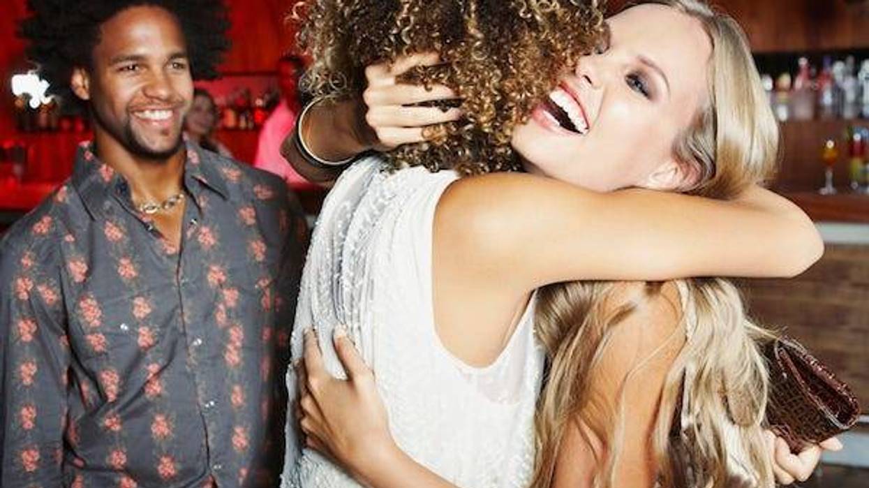 Friends hugging at a bar