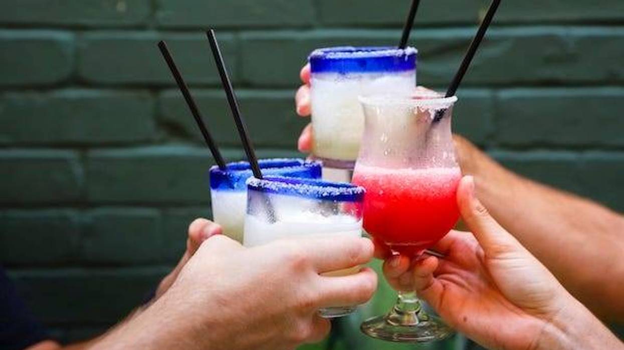 Friends toasting margaritas at restaurant