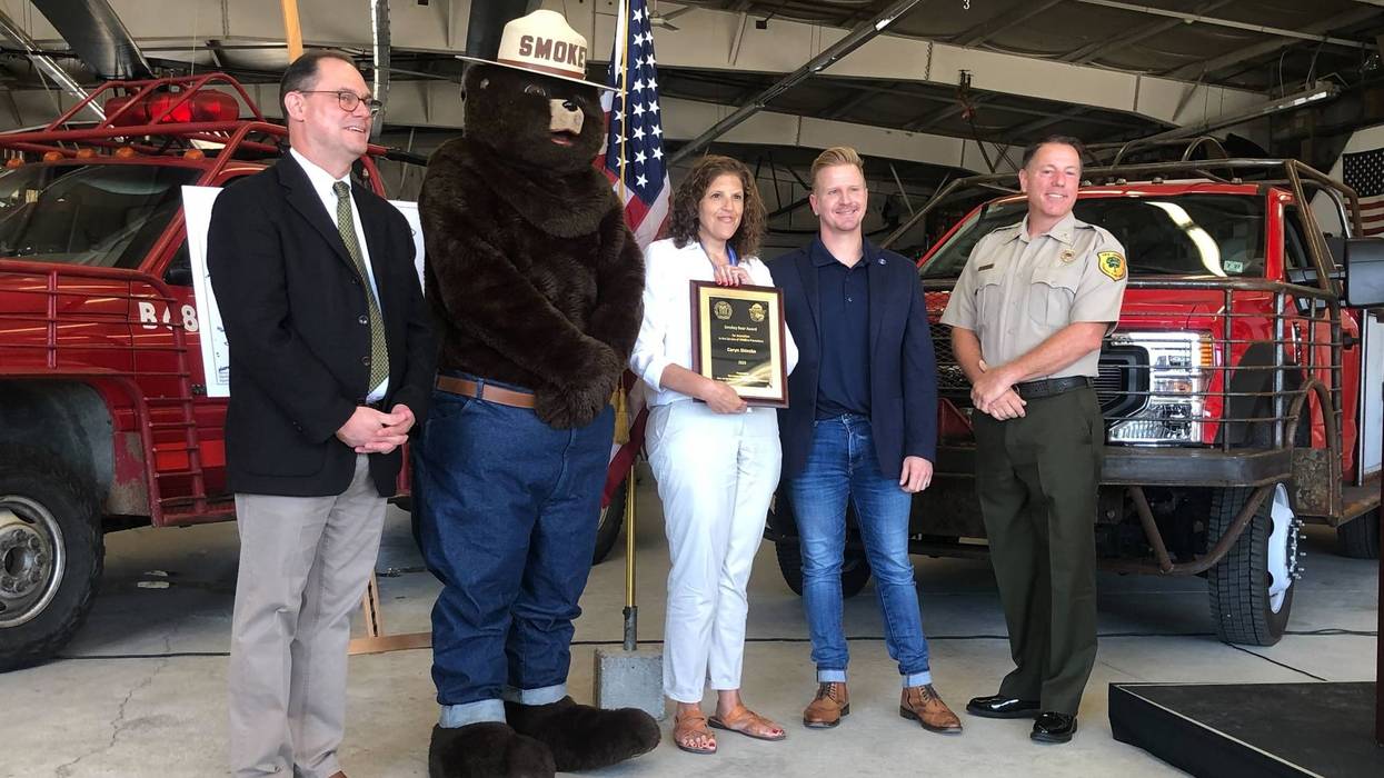 From left: Assistant Commissioner of state parks and forests John Cecil, Smokey Bear, Caryn Shinske, Shawn LaTourette, and Forest Fire Service Chief Greg McLaughlin