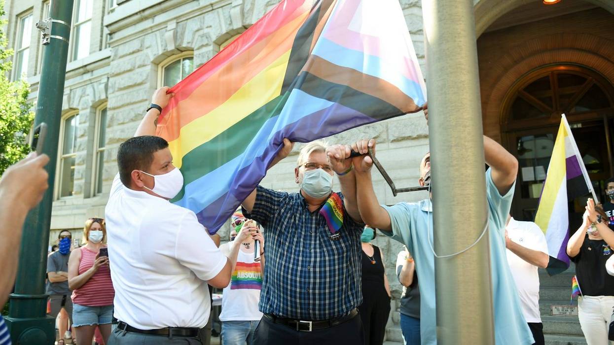 From left: Enrique Castro, vice president of the Reading Pride Celebration; Ben Renkus and Mayor Eddie Moran work together to raise the Progress Pride flag in celebration of LGBTQ Pride Month in front of Reading City Hall on Friday, June 12, 2020.