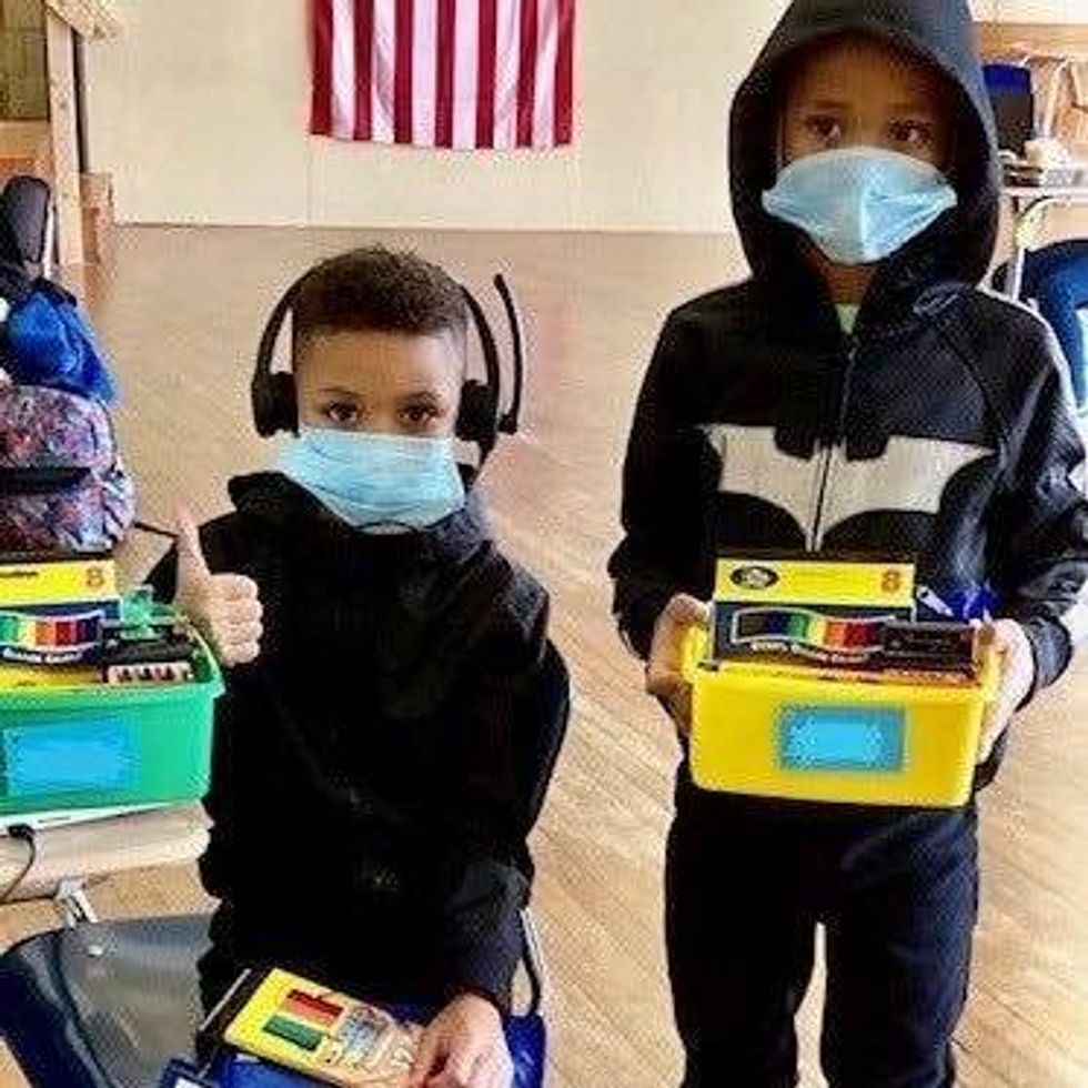 From left: Khamir and Khasim Washington attend virtual school at one of the city