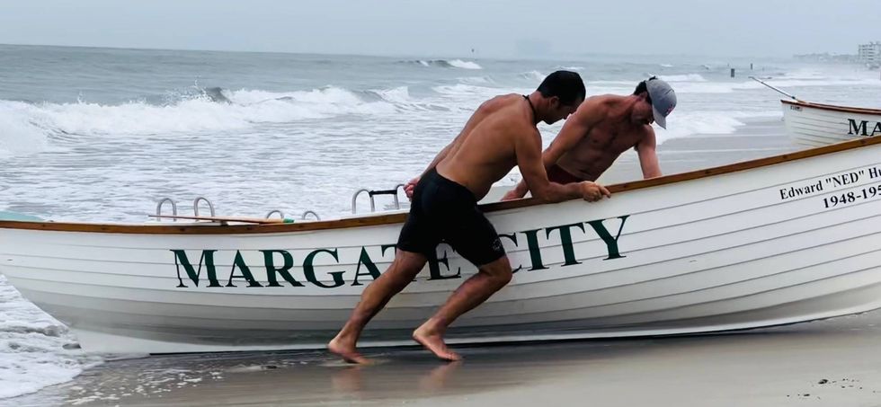 From left: Margate Beach Patrol Capt. Chris Graves and lifeguard Chris Spires pull a rescue boat back onshore.