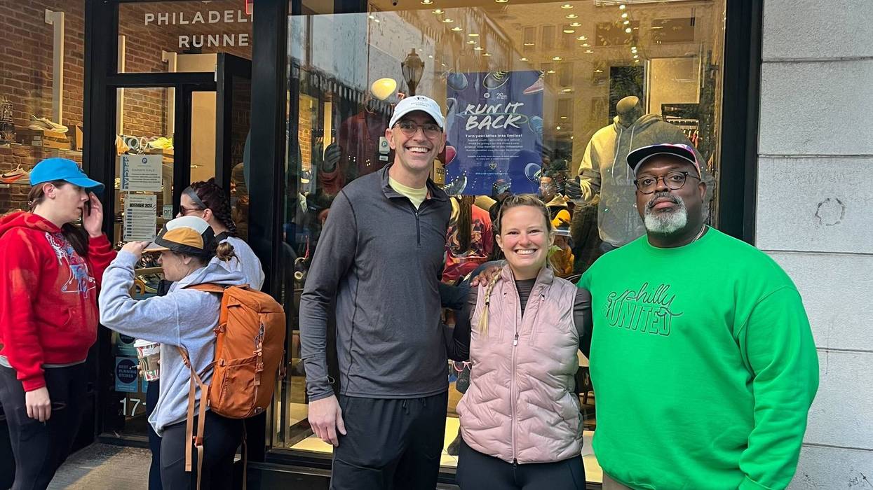 From left: Philly United Run organizers Ross Martin, Christina Shank and Lionel Brodie stand in front of Philadelphia Runner in Center City on Sunday