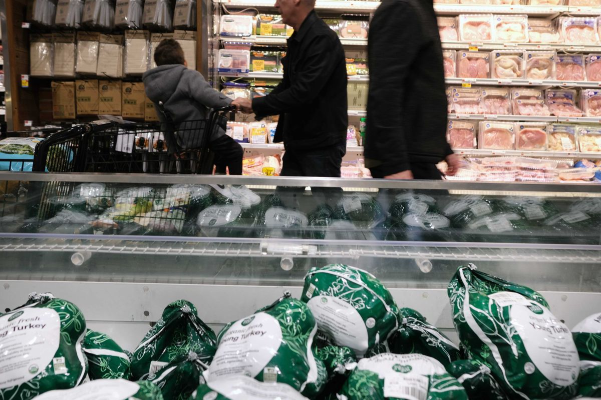 Frozen turkeys are displayed for sale inside a grocery store.