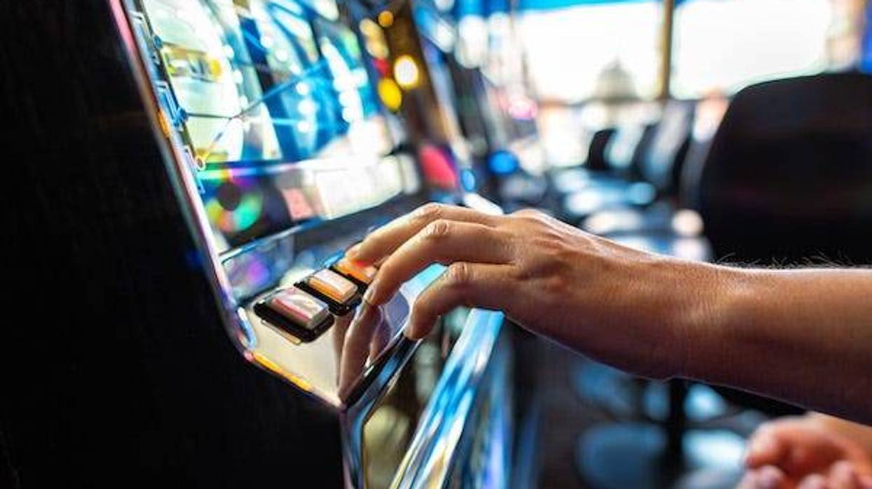 Gambler pressing a button on a machine
