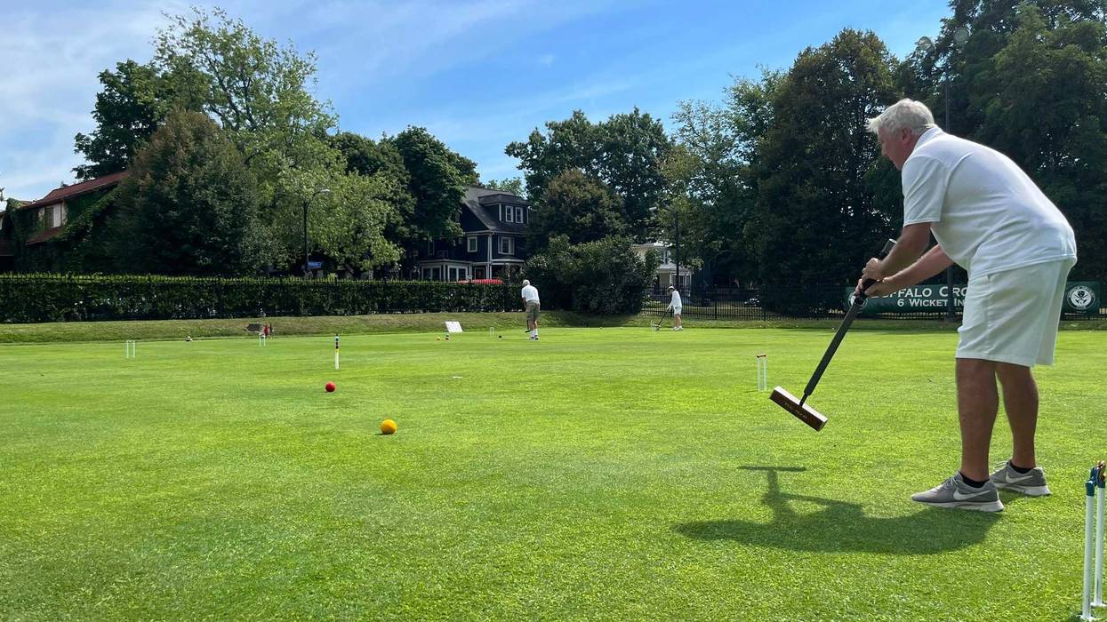 Gannon practices by taking a long whack at a far wicket in Delaware Park.