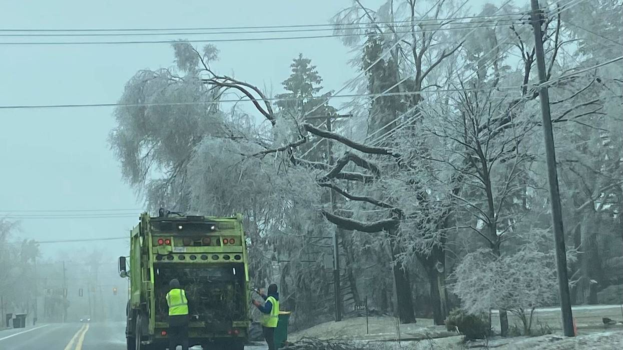Garbage truck near ice-covered trees and power lines in Farmington Hills
