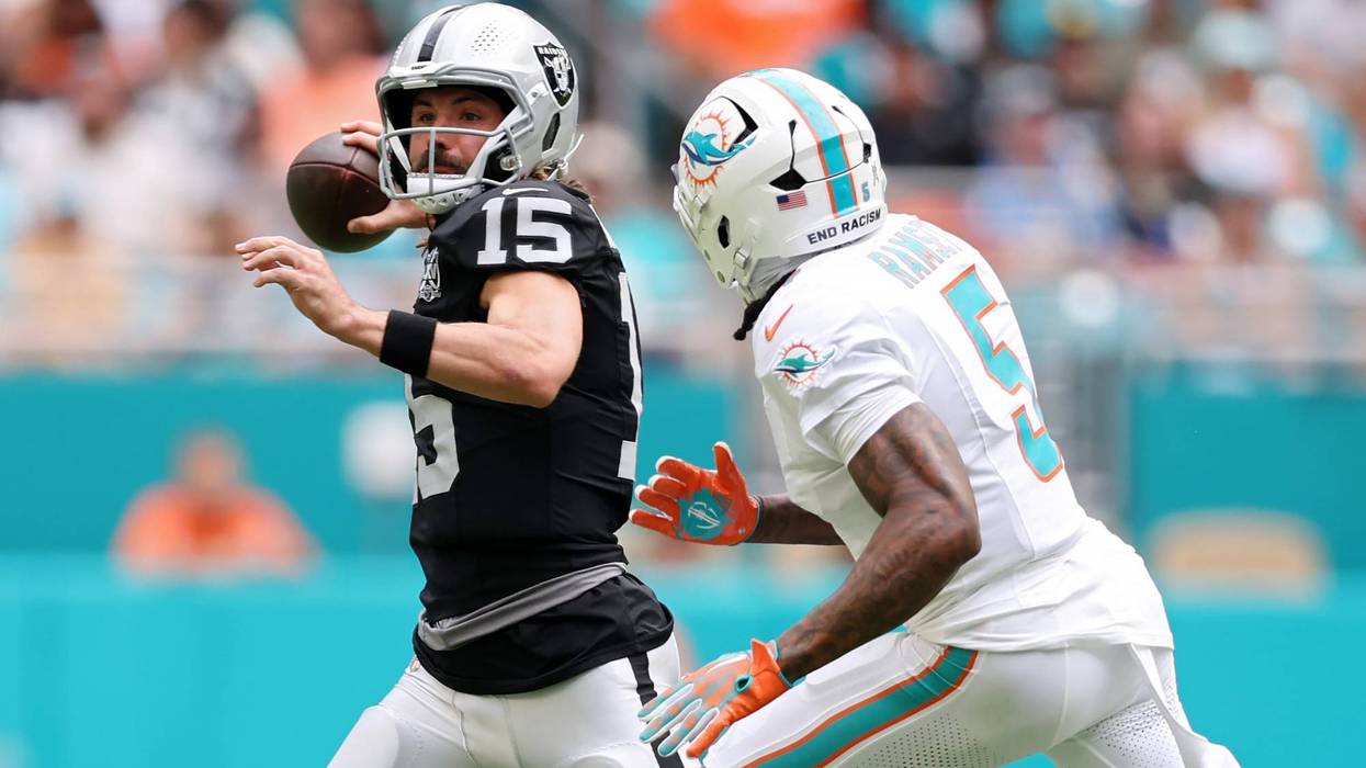 Gardner Minshew #15 of the Las Vegas Raiders looks to pass while pressured by Jalen Ramsey #5 of the Miami Dolphins in the second quarter of a game at Hard Rock Stadium on November 17, 2024 in Miami Gardens, Florida.