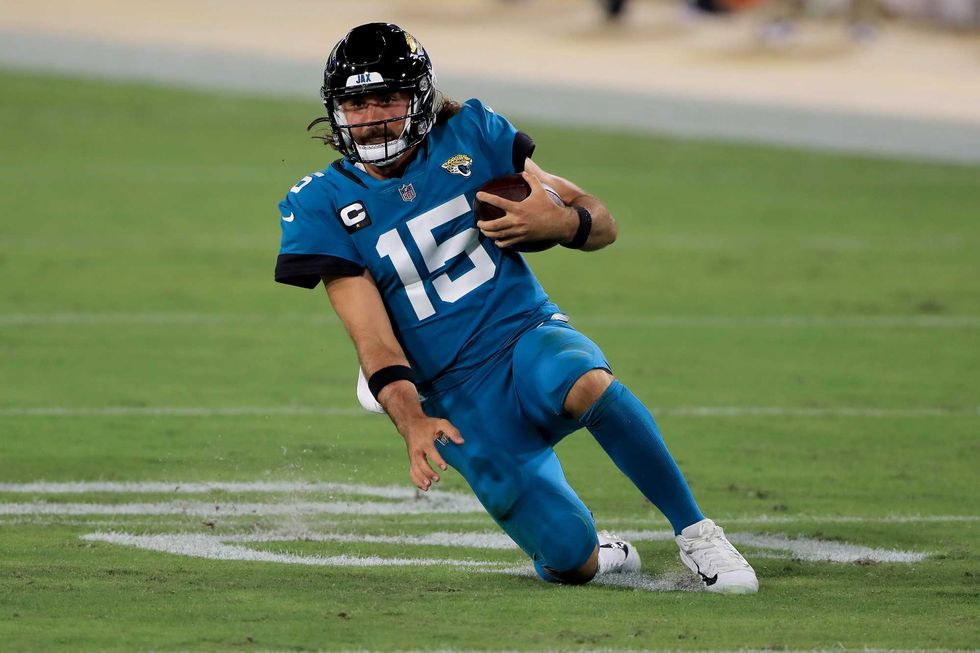 Gardner Minshew slides on the turf against Miami