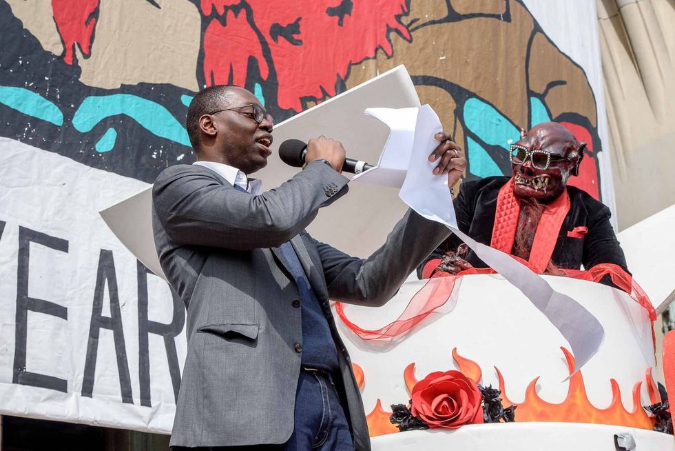 Garland Gilchrist welcomes the the Nain Rouge on the steps of Masonic Temple at the conclusion of the 10th annual Marche du Nain Rouge