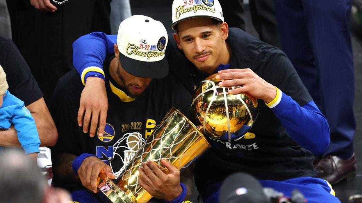 Gary Payton II #0 and Juan Toscano-Anderson #95 of the Golden State Warriors celebrate after defeating the Boston Celtics 103-90 in Game Six of the 2022 NBA Finals at TD Garden on June 16, 2022 in Boston, Massachusetts.