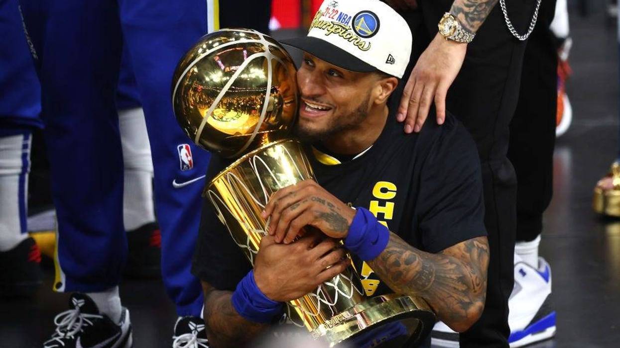 Gary Payton II #0 of the Golden State Warriors celebrates with the Larry O'Brien Championship Trophy after defeating the Boston Celtics 103-90 in Game Six of the 2022 NBA Finals at TD Garden on June 16, 2022 in Boston, Massachusetts.