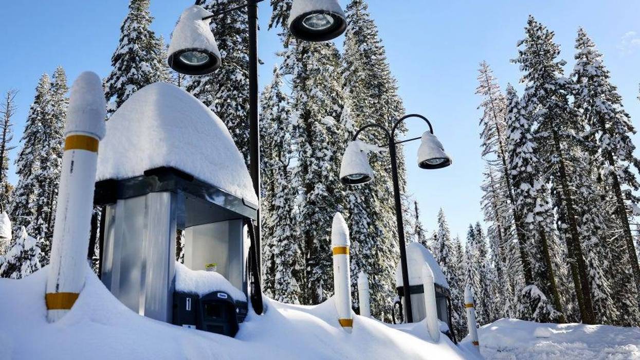 Gas pumps are partially buried in snow, at a service station closed for the winter, after a series of atmospheric river storms on January 20, 2023 in Yosemite National Park, California.