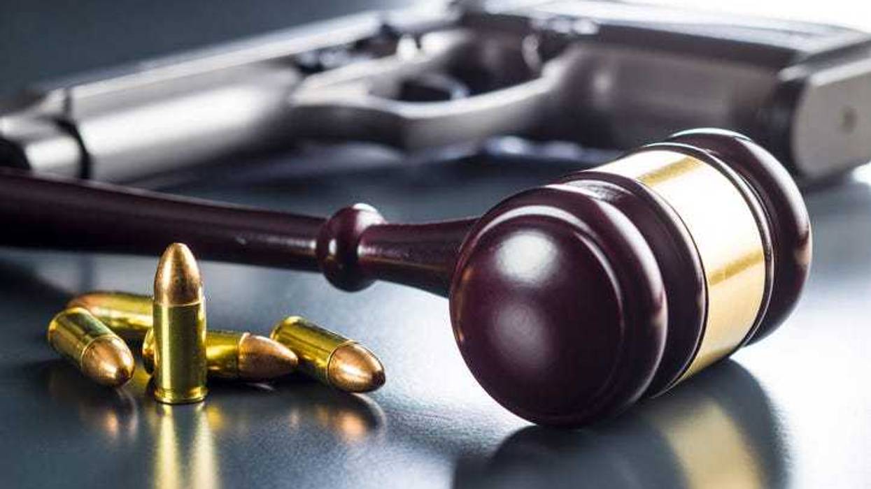 Gavel and gun on a table depicting gun legislation.