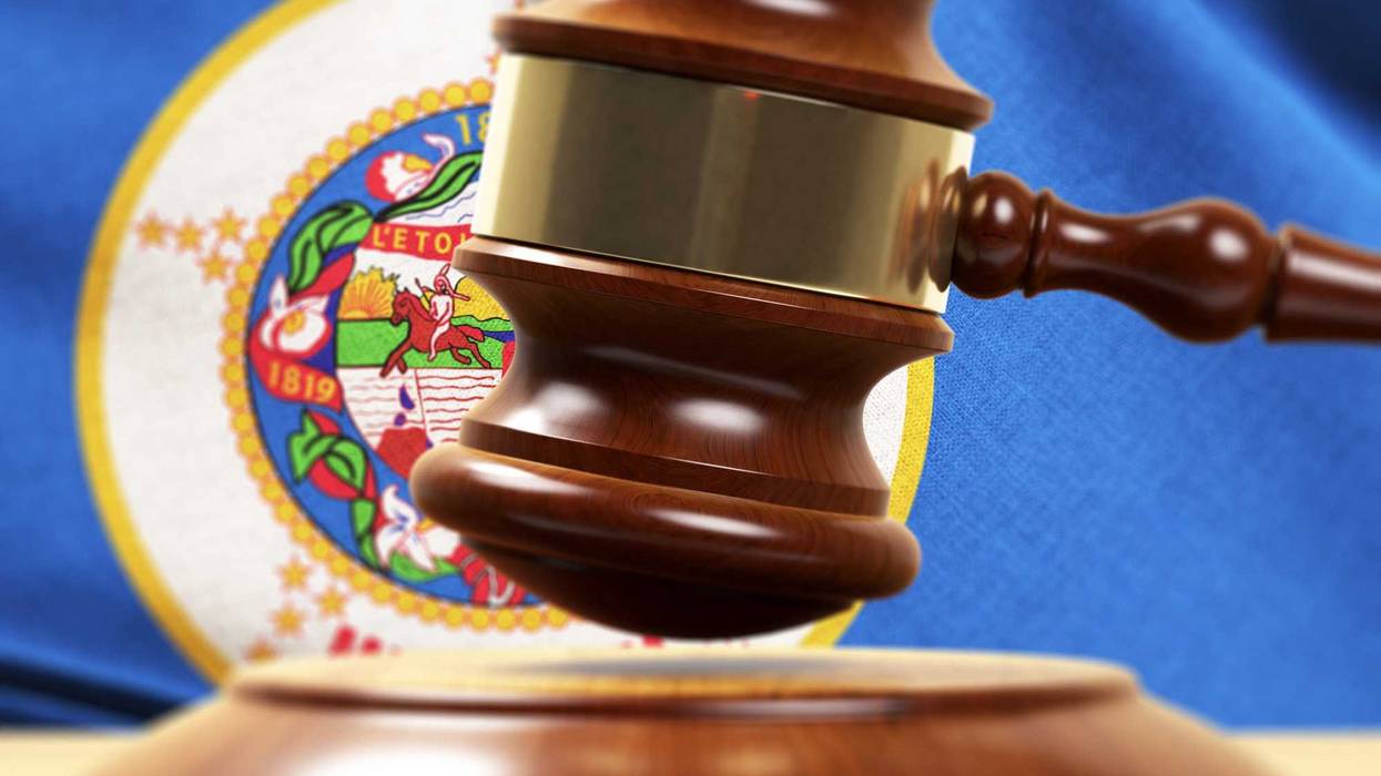 Gavel in front of a Minnesota flag.