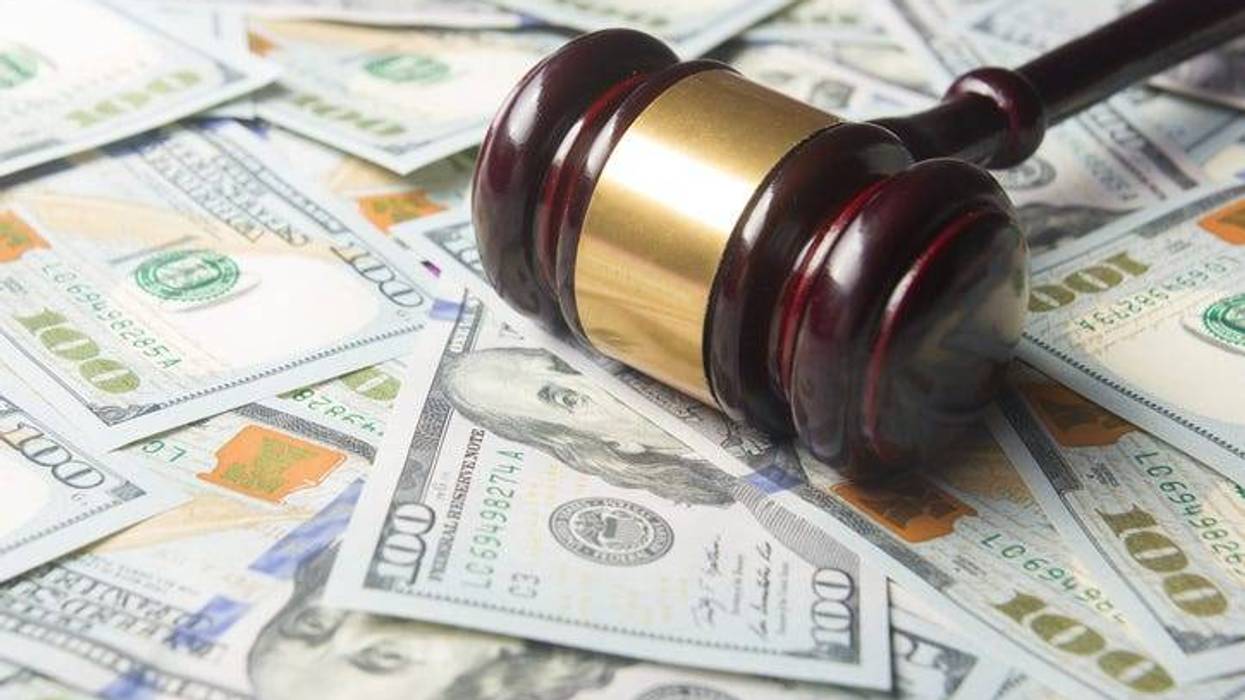 Gavel on top of $100 bills