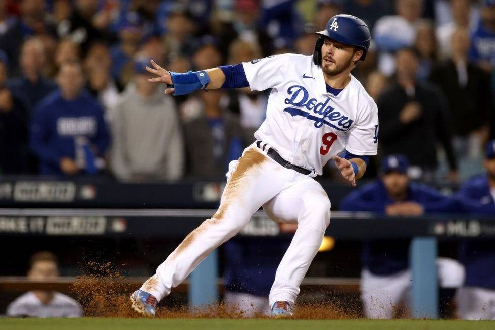 Gavin Lux #9 of the Los Angeles Dodgers is caught in a run down against the San Francisco Giants during the fifth inning in game 4.