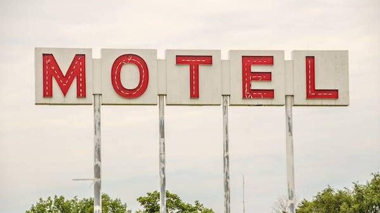 Generic motel sign in the USA with red letters on a white background