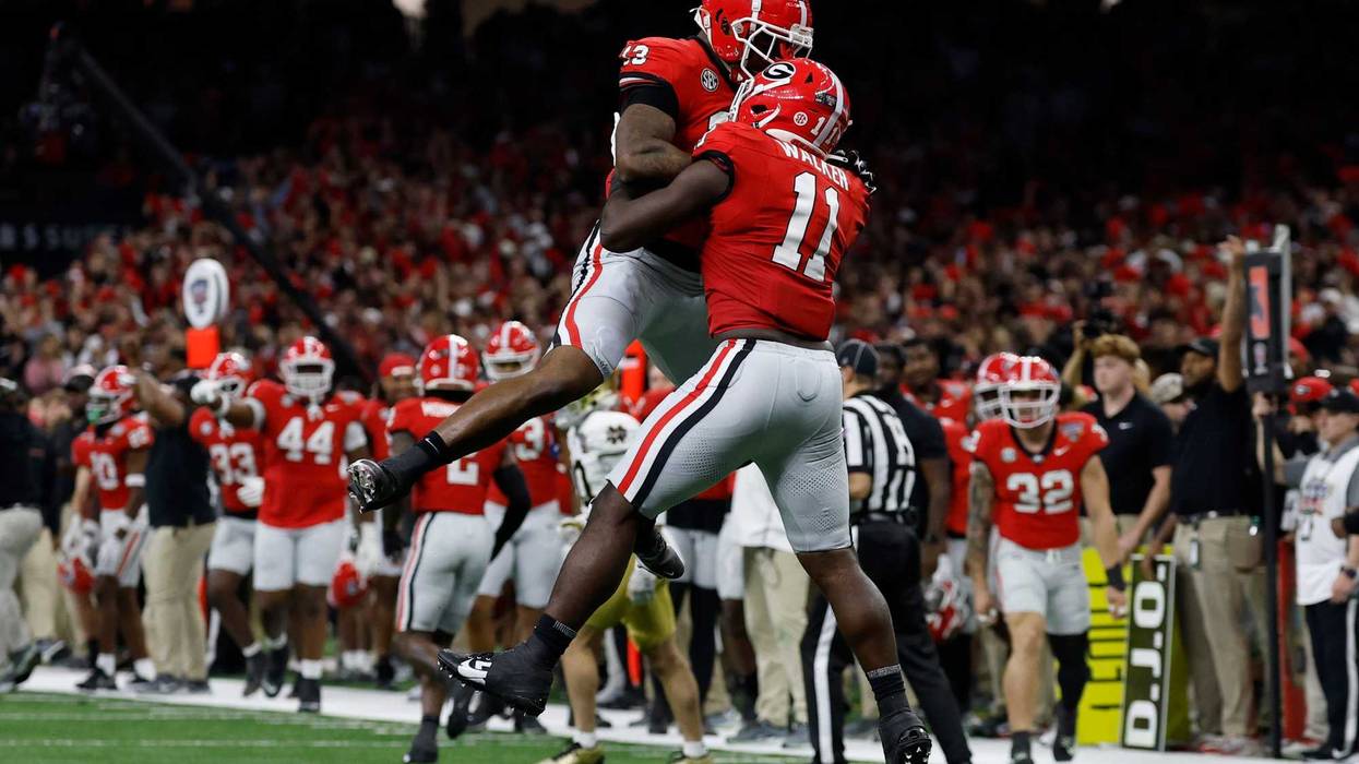 Georgia Bulldogs linebacker Jalon Walker (11) celebrates with Bulldogs defensive lineman Mykel Williams (13) after making a defensive stop