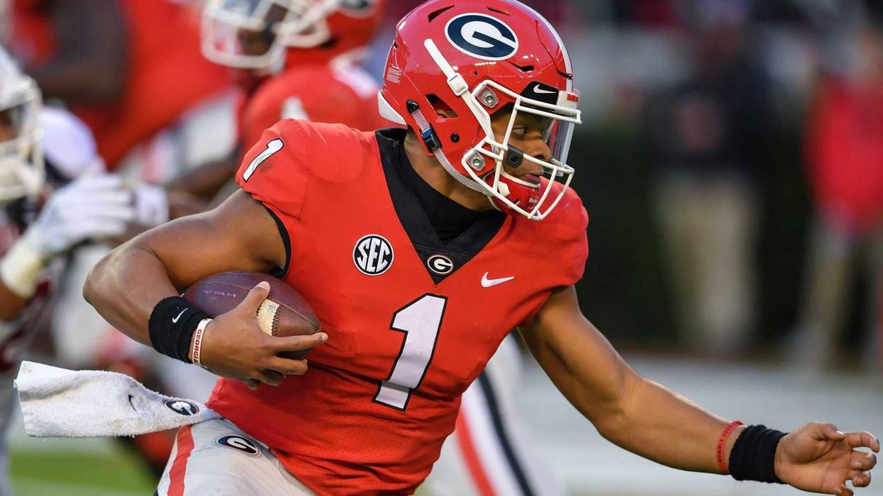 Georgia Bulldogs quarterback Justin Fields (1) runs for a touchdown against the Massachusetts Minutemen during the first half at Sanford Stadium.