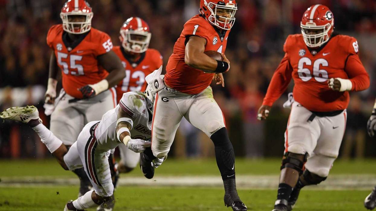 Georgia Bulldogs quarterback Justin Fields (1) runs with the ball against the Massachusetts Minutemen during the second half at Sanford Stadium.