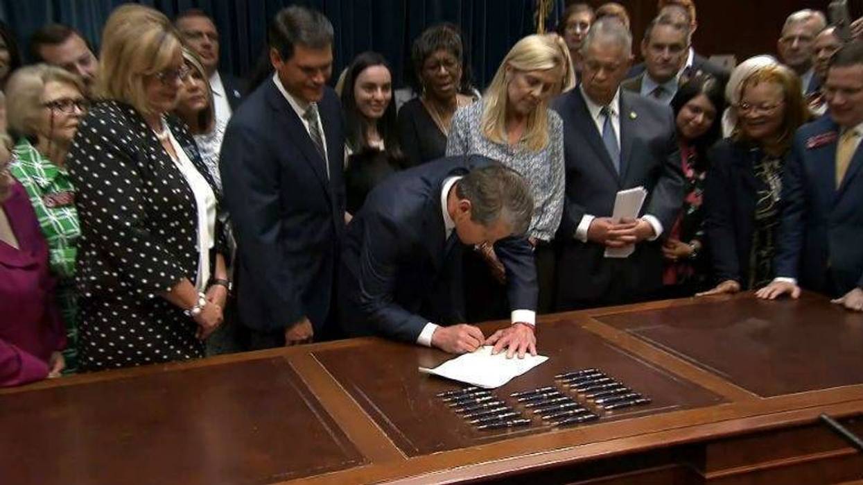 Georgia Gov. Brian Kemp signs the anti-abortion legislation Tuesday at the state Capitol in Atlanta.