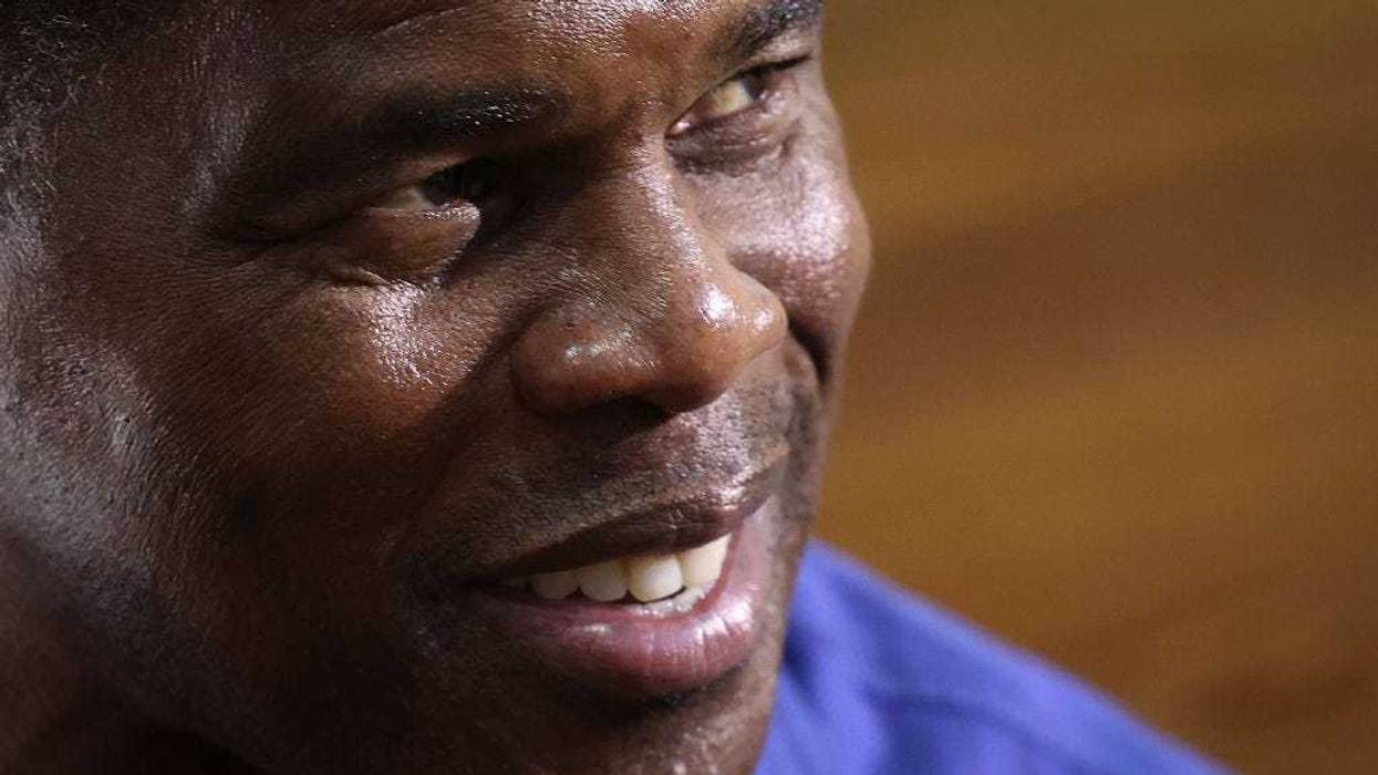 Georgia Republican senate candidate Herschel Walker talks with supporters after a campaign rally on November 30, 2022 in Dalton, Georgia. With six days to go until Georgians complete a runoff election for U.S. Senate, Herschel Walker continues to campaign across Georgia in hopes of defeating incumbent Sen. Raphael Warnock (D-GA). (Photo by Win McNamee/Getty Images)