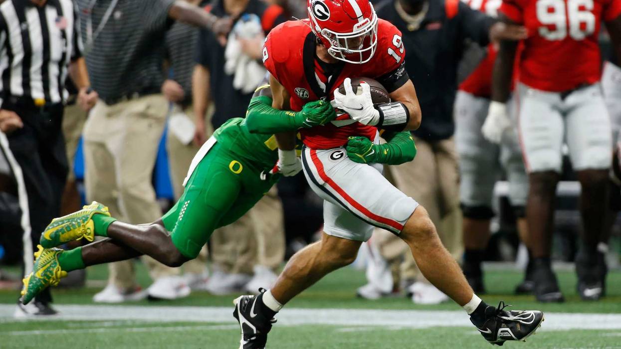 Georgia tight end Brock Bowers (19) carries an Oregon defender down the field with him during the first half of the Chick-fil-A Kickoff at the Mercedes-Benz Dome in Atlanta, on Saturday, Sept. 3, 2022.
