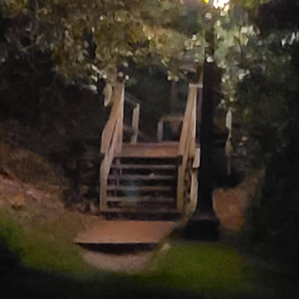 Ghostly figure sitting on a staircase