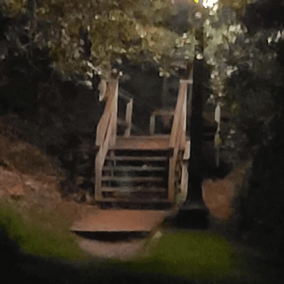 Ghostly figure sitting on a staircase