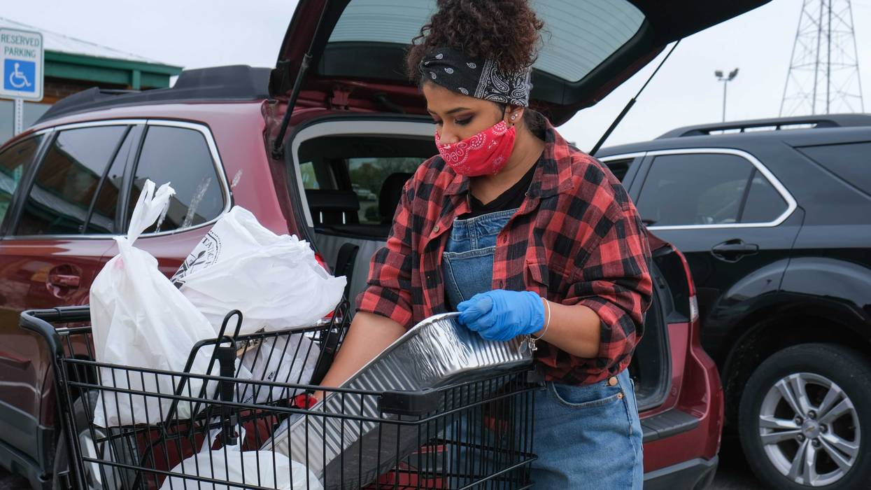 Gianna Prestol loads groceries into a car at the Texas Roadhouse drive-up farmer s market in Milford, Ohio on Sunday, April 19, 2020. Texas Roadhouse Farmers Market6812