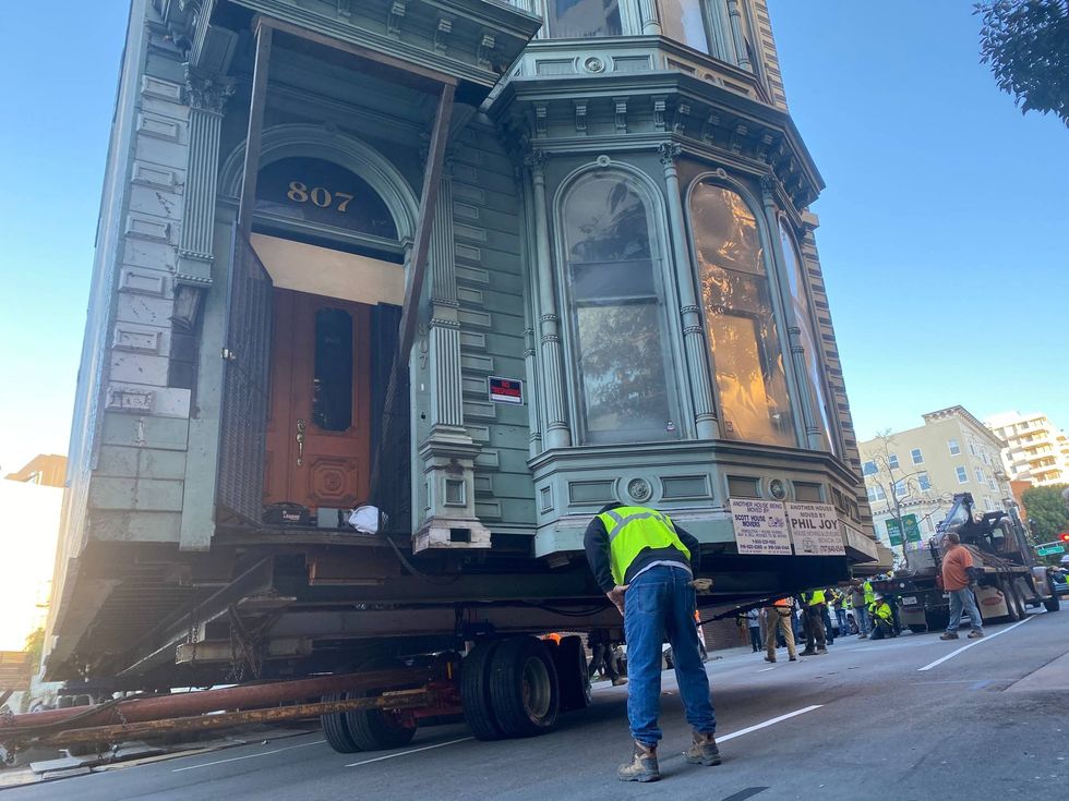 Giant dollies support the home, which went from 870 Franklin St. to its new location at 635 Fulton St. in San Francisco.
