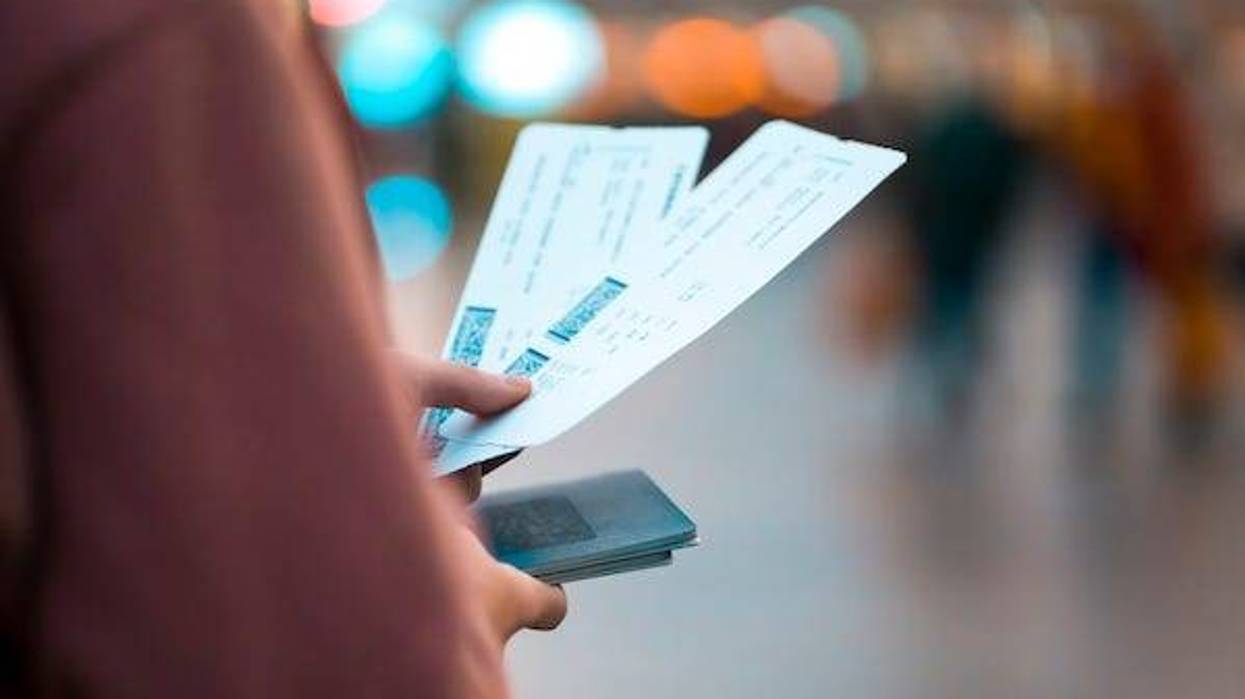 Girl holds tickets, boarding passes for a flight
