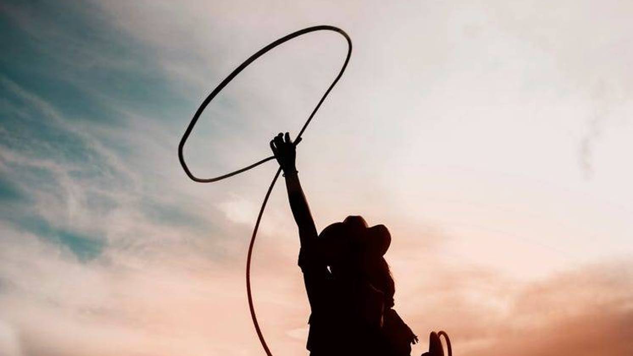 girl on horse throwing a lasso