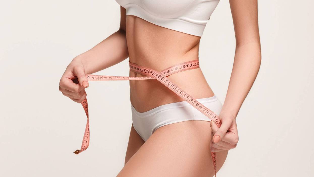 girl taking measurements of her body
