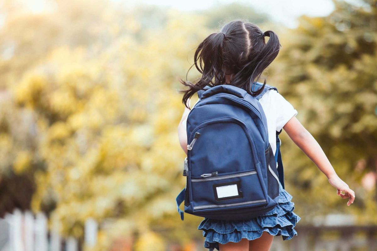 Girl with backpack running and going to school.