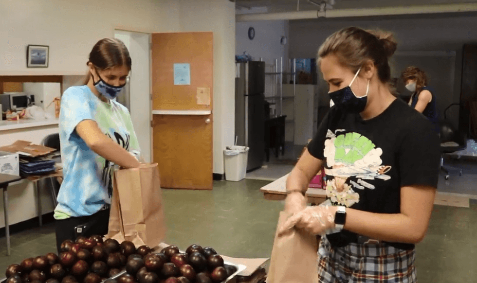 Girls pack fruit in bags