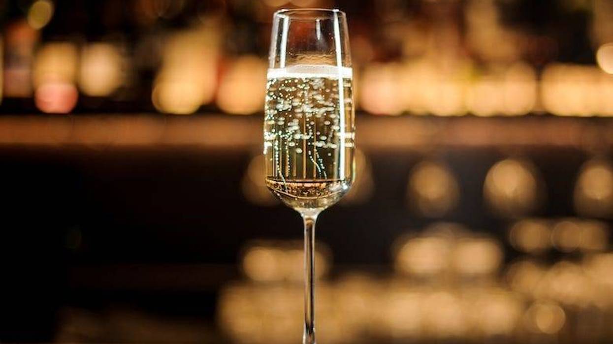 Glass of Champagne standing on a bar counter