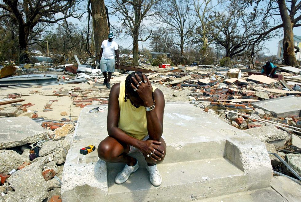 Glenda Thomas sits on the steps which used to be the front of her home September 2, 2005 in Gulfport, Mississippi. Rescue efforts continue as officials in New Orleans and Mississippi fear the death toll from the devasting storm could be in the thousands. (Photo by Ross Taylor/Getty Images)